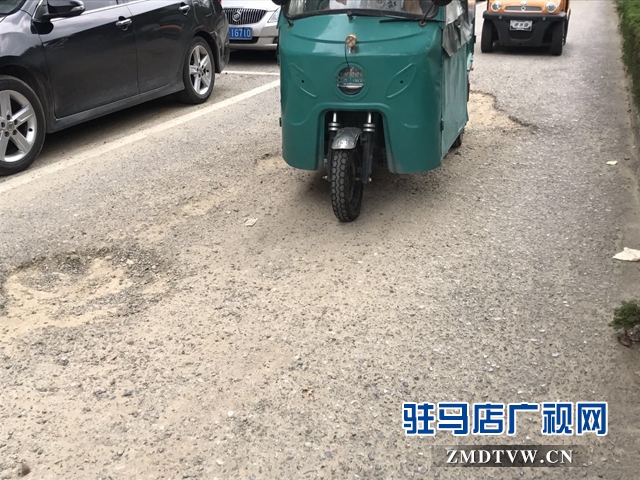 市区慎阳路西段道路坑连坑  居民追问何时能修